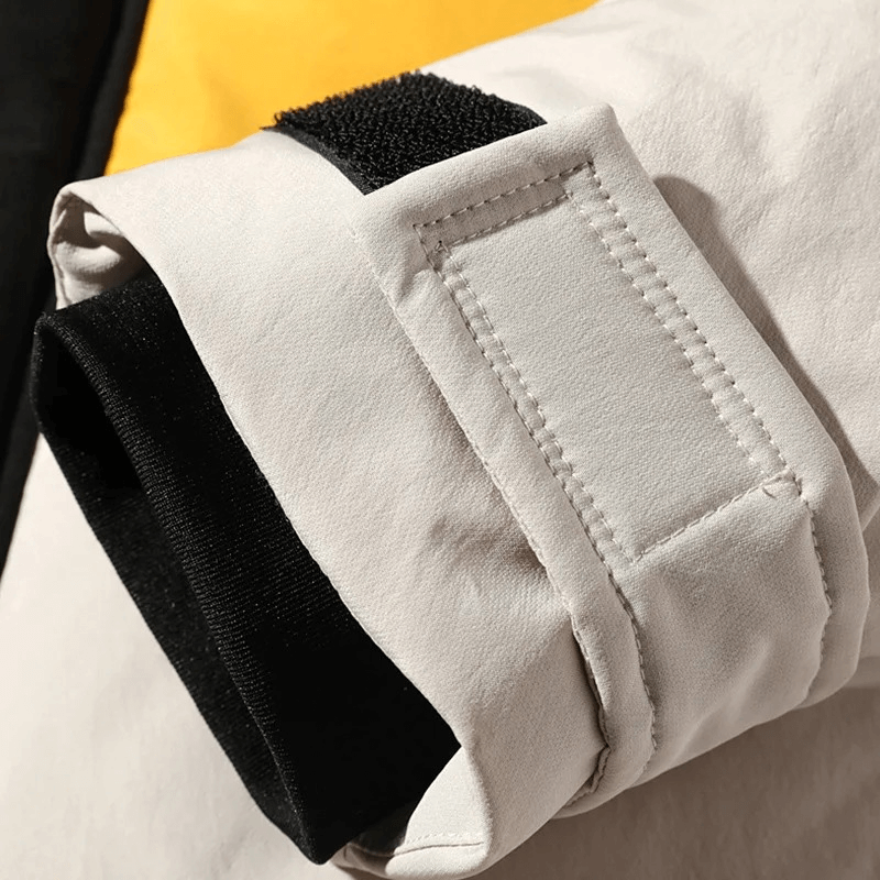 Close-up of stylish men's down jacket sleeve with Velcro, showing durable polyester fabric and thermal lining, ideal for winter.